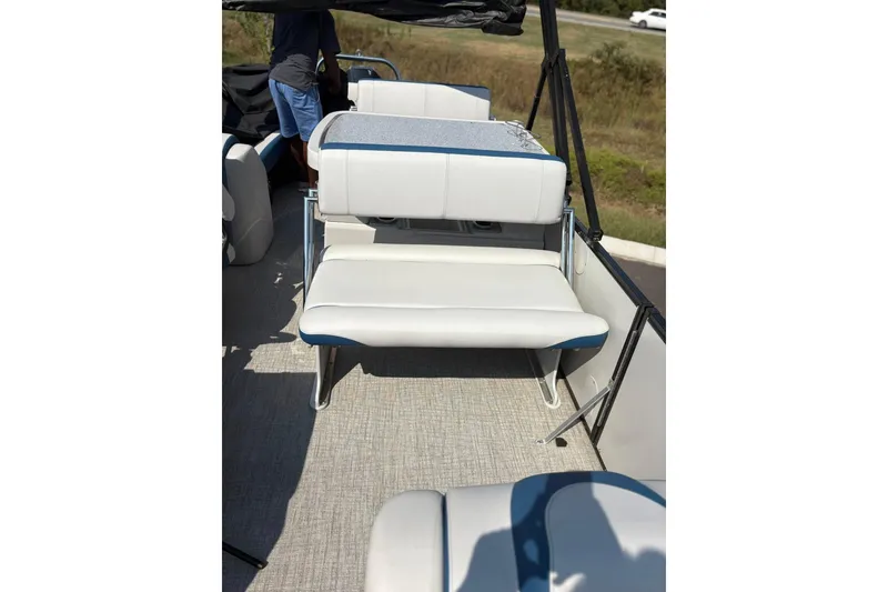 Slide: The Image of 2024 Avalon Catalina Entertainer boat interior with white seating and blue accents. - 10