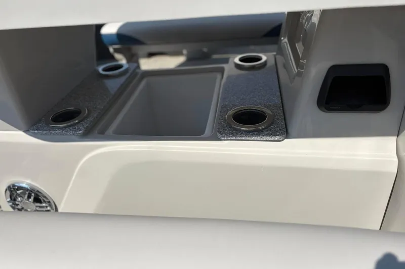 Slide: The Image of 2024 Avalon Catalina Entertainer boat interior with cup holders and storage compartment. - 16