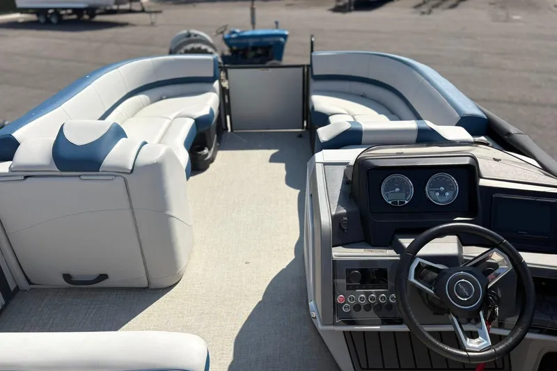 Slide: The Image of 2024 Avalon Catalina Entertainer boat interior with plush seating and modern dashboard. - 17