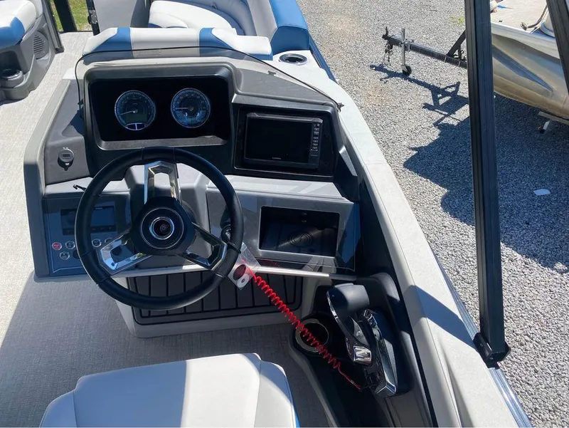 Slide: The Image of 2024 Avalon Catalina Entertainer boat dashboard with steering wheel and control panel. - 3