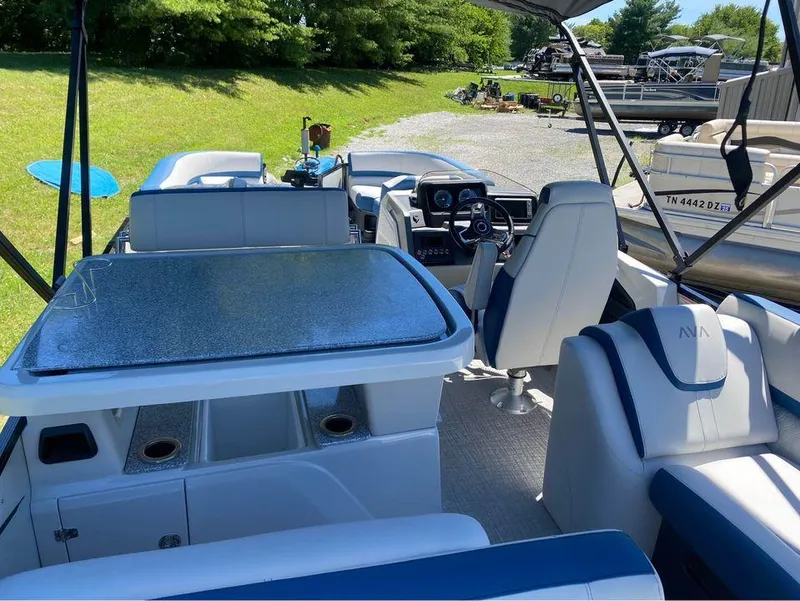 Slide: The Image of 2024 Avalon Catalina Entertainer boat interior with seating, table, and steering console. - 4