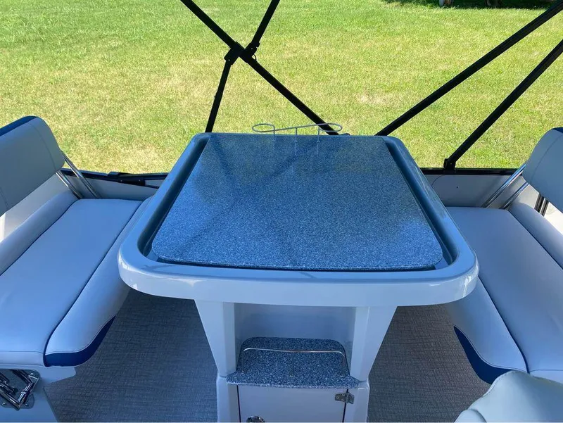 Slide: The Image of 2024 Avalon Catalina Entertainer boat interior with seating and table setup. - 5