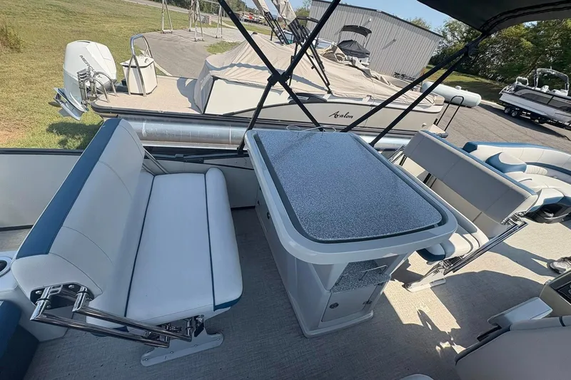 Slide: The Image of 2024 Avalon Catalina Entertainer boat interior with seating and table setup. - 9