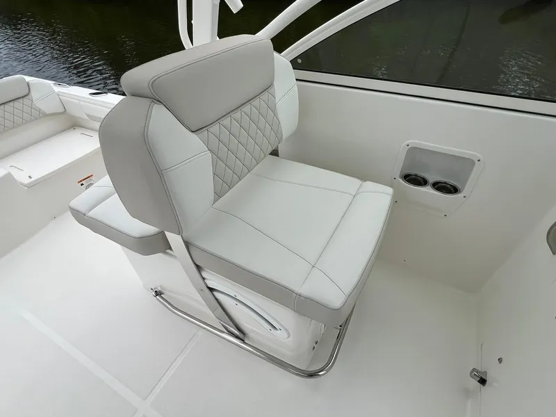 Slide: The Image of Luxury seating on 2025 World Cat 230 DC boat, featuring elegant design and cup holders. - 13