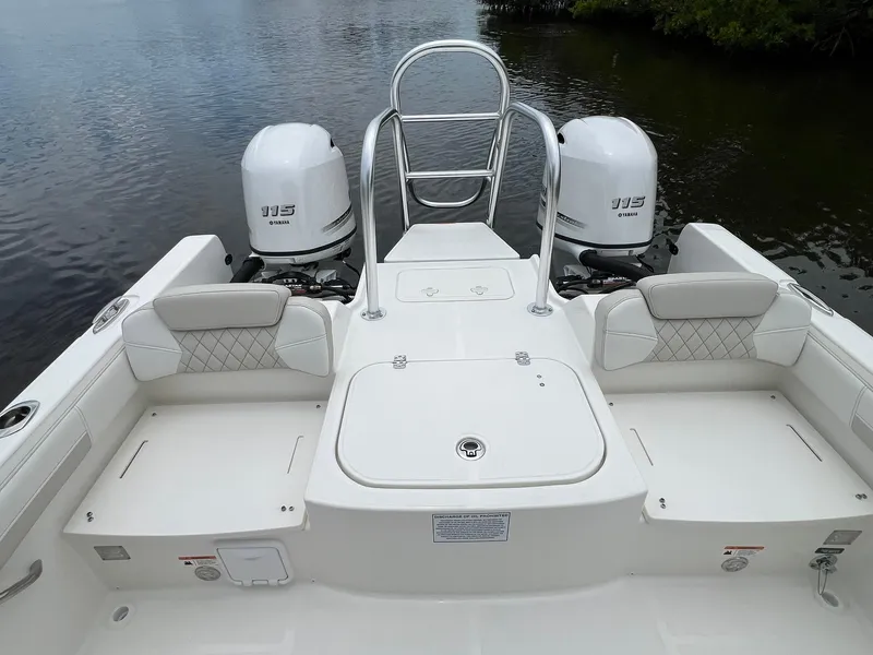 Slide: The Image of 2025 World Cat 230 DC boat with dual Yamaha 115 engines on calm water. - 16