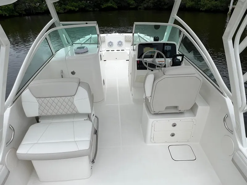 Slide: The Image of 2025 World Cat 230 DC boat interior with modern seating and steering console. - 18