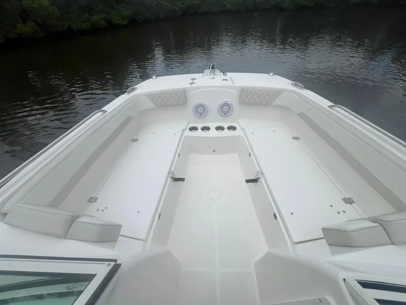 Slide: The Image of 2025 World Cat 230 DC boat interior with spacious seating on calm water. - 8