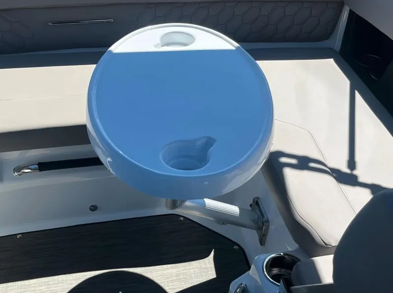 Slide: The Image of 2023 Four Winns H1 boat interior with round table and seating area. - 14