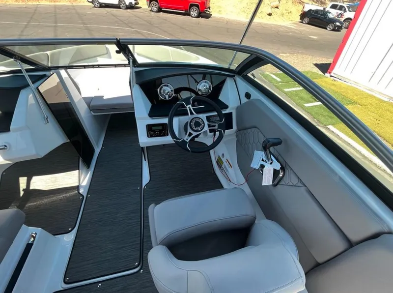 Slide: The Image of 2023 Four Winns H1 boat interior with steering wheel and seating. - 15