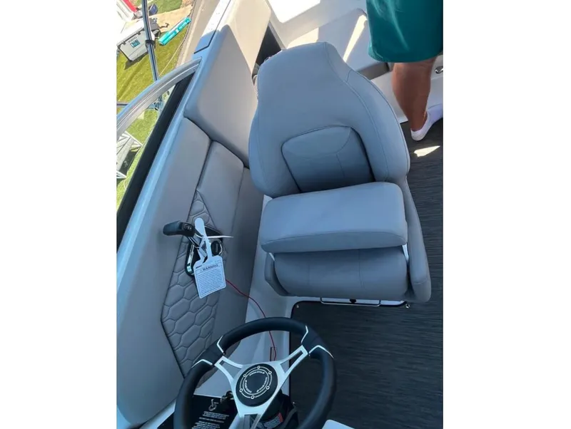Slide: The Image of 2023 Four Winns H1 boat interior with gray seating and steering wheel. - 20