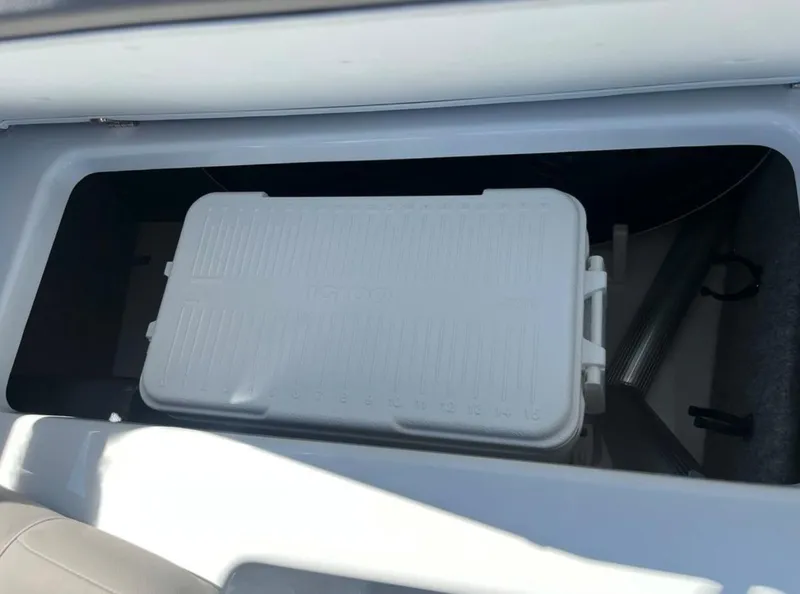 Slide: The Image of Storage compartment in 2023 Four Winns H1 boat with a white cooler inside. - 22