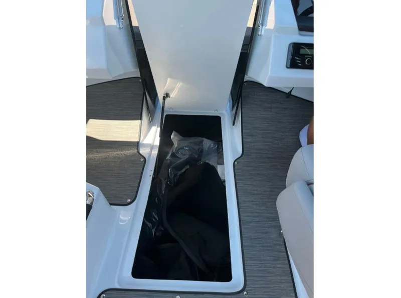 Slide: The Image of 2023 Four Winns H1 boat storage compartment with open hatch, showcasing interior space. - 24