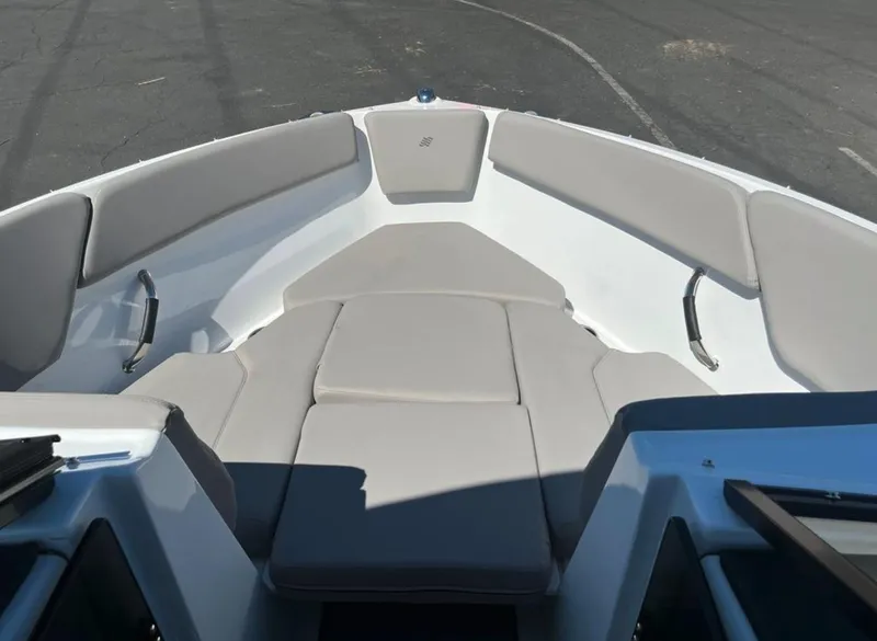 Slide: The Image of 2023 Four Winns H1 boat interior with cushioned seating and sleek design. - 26