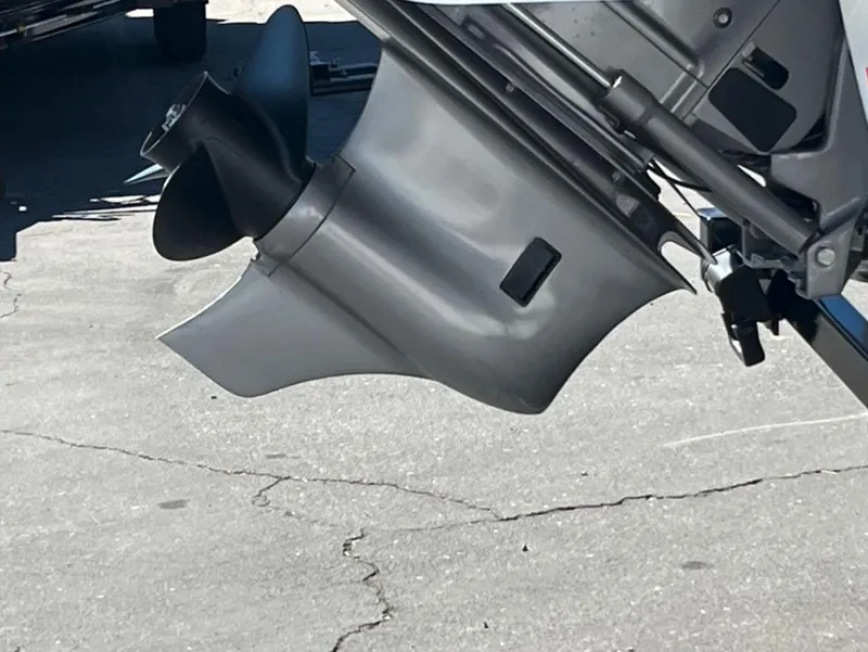 Slide: The Image of 2023 Four Winns H1 boat propeller and outdrive on pavement. - 3
