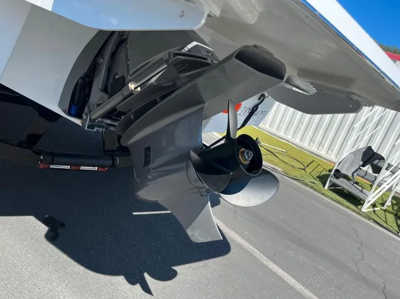 Slide: The Image of 2023 Four Winns H1 boat propeller and stern drive in a parking area. - 4