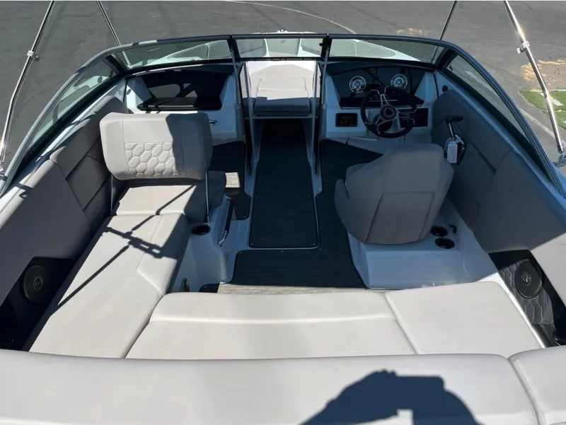 Slide: The Image of 2023 Four Winns H1 boat interior with gray seating and modern dashboard. - 9