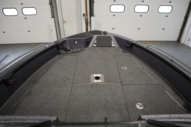 Slide: The Image of 2023 Lund 189 PRO V boat interior with spacious deck and storage compartments. - 11