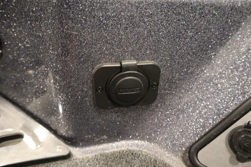 Slide: The Image of 2023 Lund 189 PRO V boat detail showing a power outlet on a textured surface. - 13