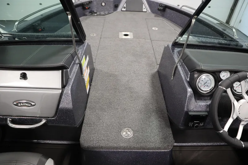 Slide: The Image of 2023 Lund 189 PRO V boat interior with steering wheel and dashboard controls. - 21