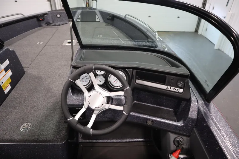 Slide: The Image of 2023 Lund 189 PRO V boat interior with steering wheel and dashboard controls. - 26