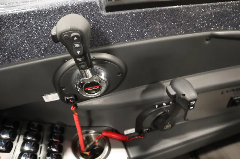 Slide: The Image of 2023 Lund 189 PRO V boat controls with Mercury throttle and trim switches. - 32
