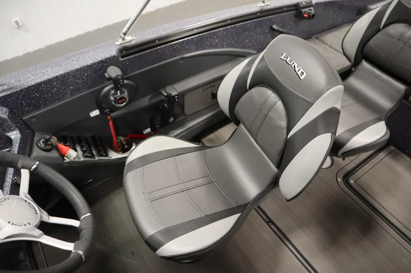 Slide: The Image of 2023 Lund 189 PRO V boat interior with sleek seating and modern controls. - 33