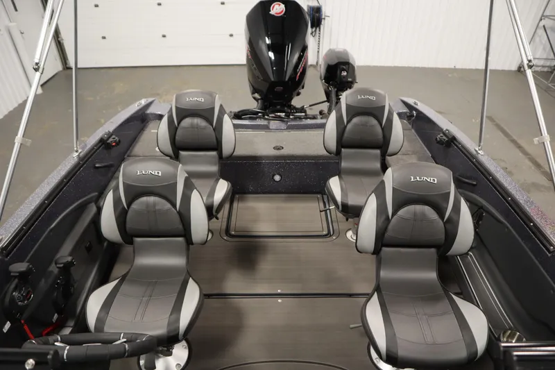 Slide: The Image of 2023 Lund 189 PRO V boat interior with four cushioned seats and motor. - 39