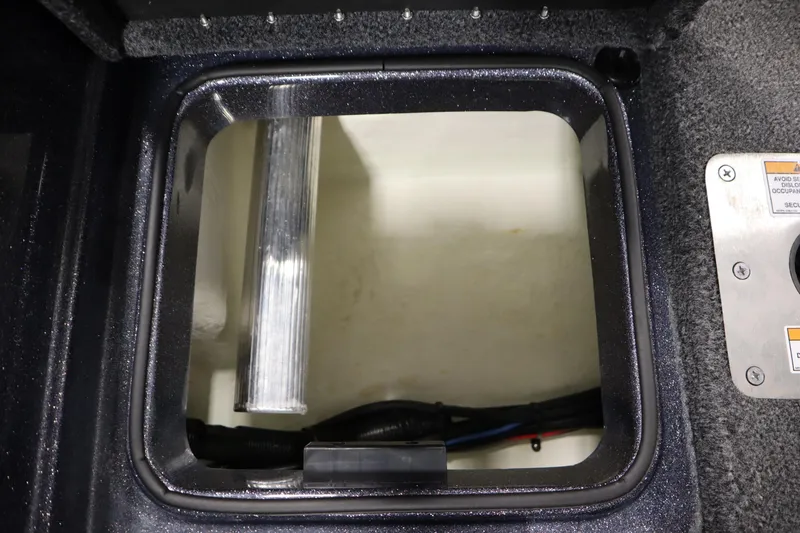 Slide: The Image of 2023 Lund 189 PRO V boat storage compartment with wiring and metal components. - 45