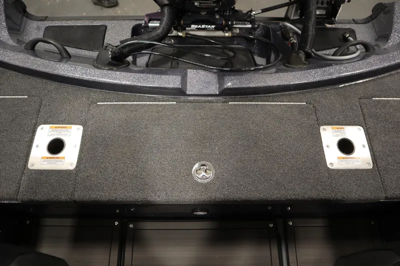 Slide: The Image of 2023 Lund 189 PRO V boat interior with carpeted deck and storage compartments. - 46