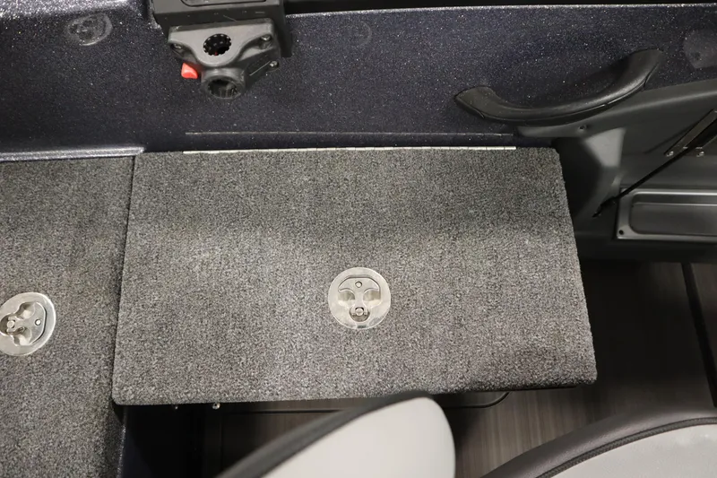 Slide: The Image of 2023 Lund 189 PRO V boat interior with carpeted deck and storage latch. - 48