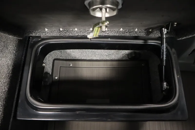 Slide: The Image of 2023 Lund 189 PRO V storage compartment with hydraulic lift and carpeted interior. - 49