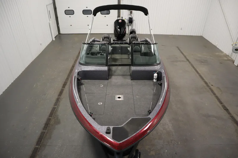 Slide: The Image of 2023 Lund 189 PRO V boat in a garage, showcasing sleek design and spacious interior. - 9