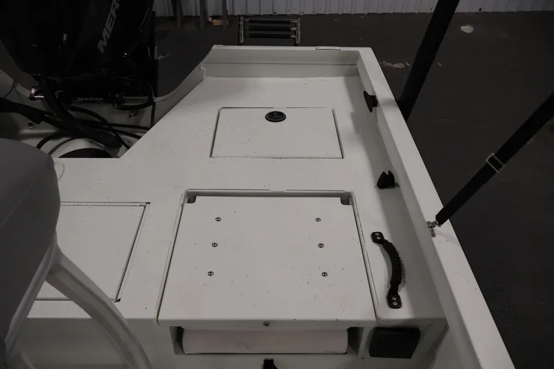 Slide: The Image of 2022 Crestliner 2200 Bay boat deck with storage compartments and motor. - 32