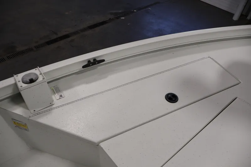 Slide: The Image of 2022 Crestliner 2200 Bay boat deck with storage compartment and rod holder. - 15