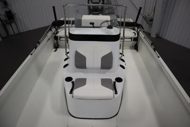 Slide: The Image of 2022 Crestliner 2200 CC boat interior with steering console and seating. - 19