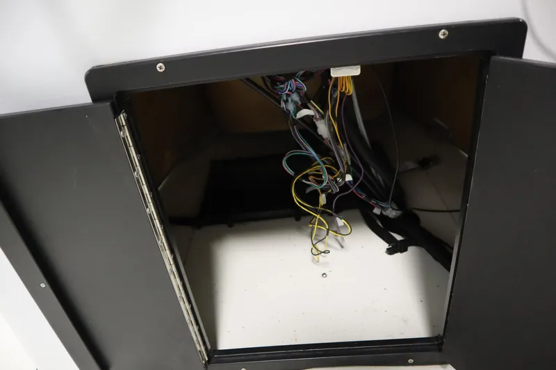 Slide: The Image of Open compartment with exposed wiring in 2022 Crestliner 2200 CC boat. - 31