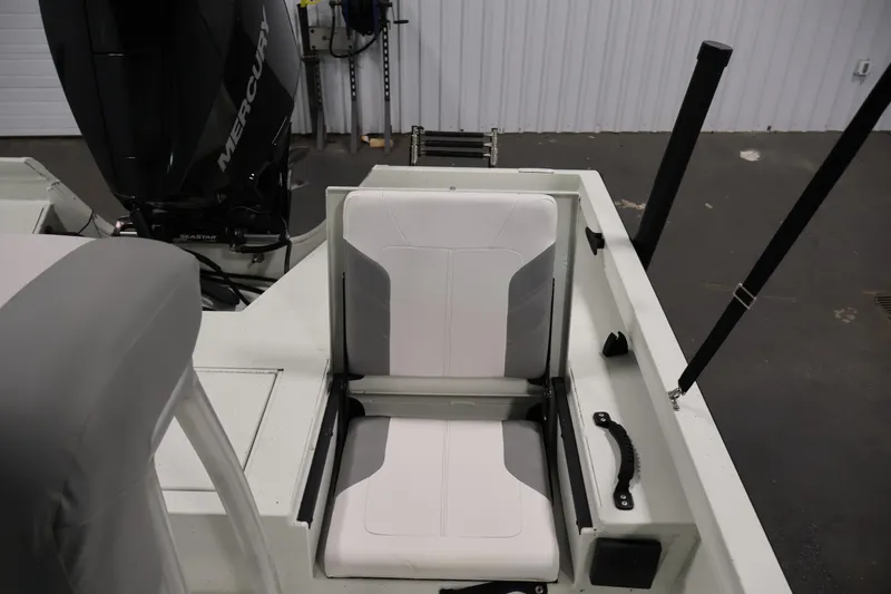 Slide: The Image of 2022 Crestliner 2200 Bay boat interior with Mercury engine, featuring comfortable seating. - 31