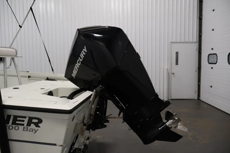 Slide: The Image of 2022 Crestliner 2200 Bay boat with Mercury outboard motor in a garage. - 42