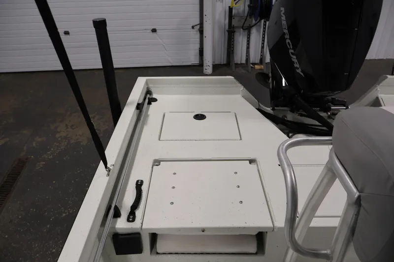 Slide: The Image of 2022 Crestliner 2200 Bay boat interior with storage compartments and Mercury engine. - 35