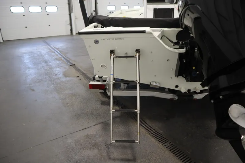 Slide: The Image of 2022 Crestliner 2200 CC Saltwater Edition boat with ladder in a garage. - 44