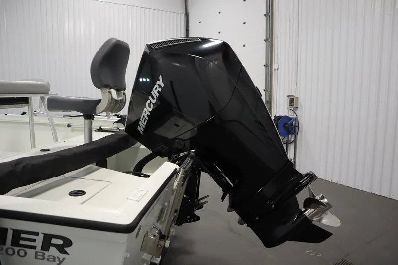 Slide: The Image of 2022 Crestliner 2200 CC boat with Mercury outboard motor in a garage setting. - 45