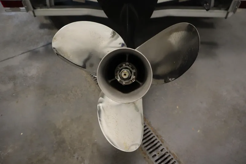 Slide: The Image of Close-up of a 2022 Crestliner 2200 CC boat propeller in a garage setting. - 47