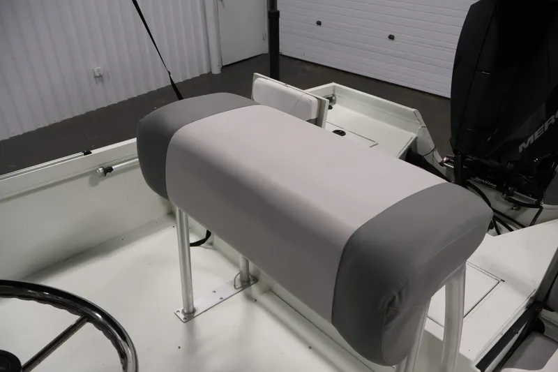 Slide: The Image of 2022 Crestliner 2200 Bay boat interior with cushioned seating and steering wheel. - 30