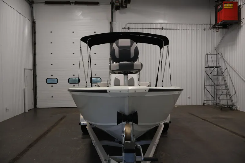 Slide: The Image of 2022 Crestliner 2200 Bay boat in indoor storage, front view with canopy. - 3