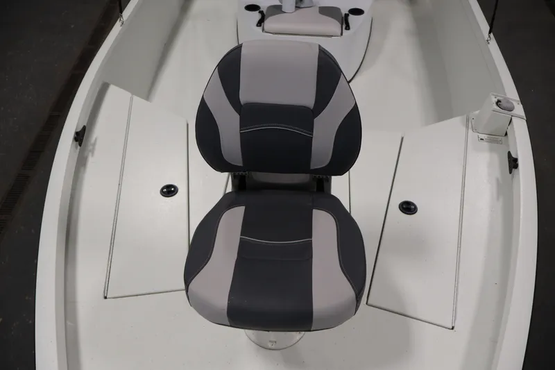 Slide: The Image of 2022 Crestliner 2200 Bay boat interior with cushioned seating and storage compartments. - 14