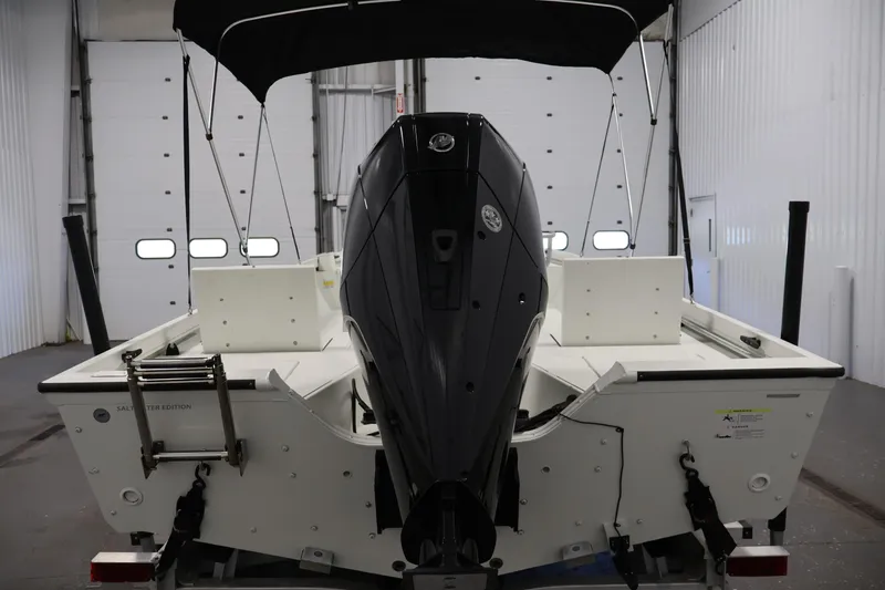 Slide: The Image of 2022 Crestliner 2200 Bay boat with outboard motor in a garage setting. - 7