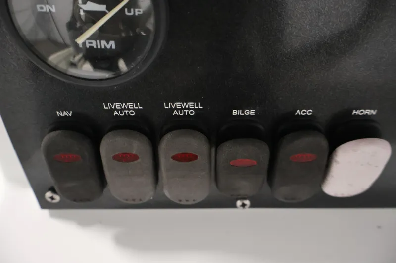 Slide: The Image of Control panel of 2022 Crestliner 2200 Bay boat with various switches and trim gauge. - 27