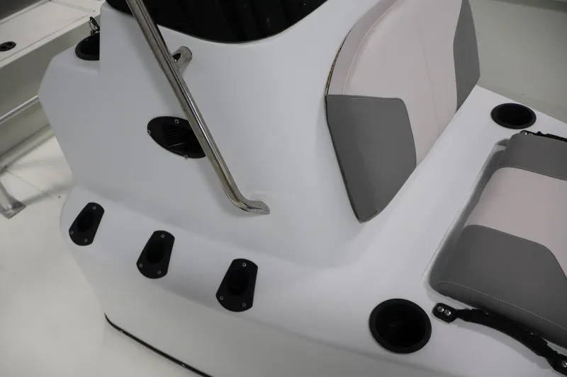 Slide: The Image of 2022 Crestliner 2200 Bay boat interior with rod holders and cushioned seating. - 21