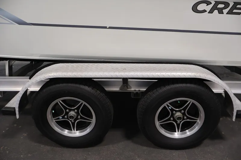 Slide: The Image of Trailer wheels of a 2022 Crestliner 2200 Bay boat, featuring sleek alloy rims. - 47