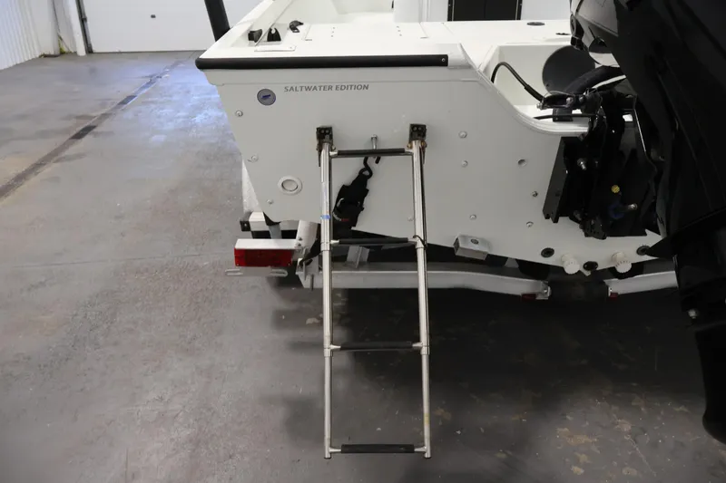 Slide: The Image of 2022 Crestliner 2200 Bay boat rear view with ladder and motor in a garage. - 41